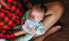 kojenec pije méko z dětské lahve